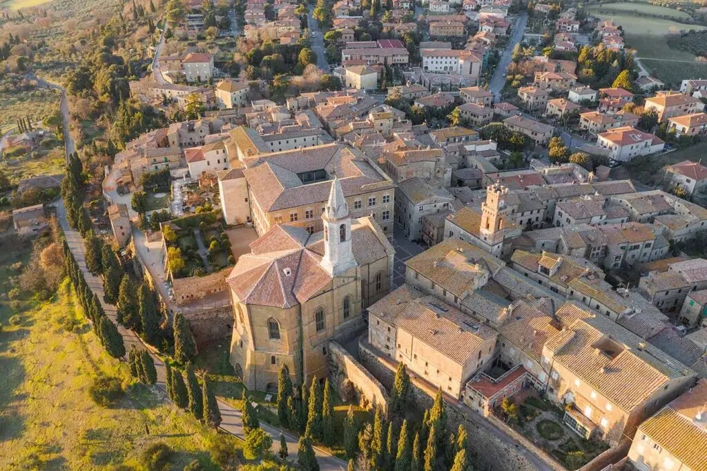 Aerial view of Pienza in Tuscany, Italy showcasing the historic architecture and scenic layout of the town during sunset.