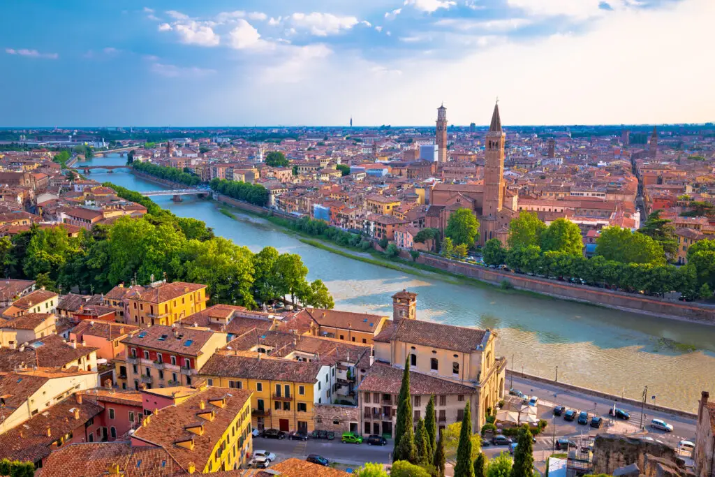 Panoramic view of Verona Italy showing the Adige River historic buildings and city skyline at sunset perfect for European private tours and Italy travel experiences