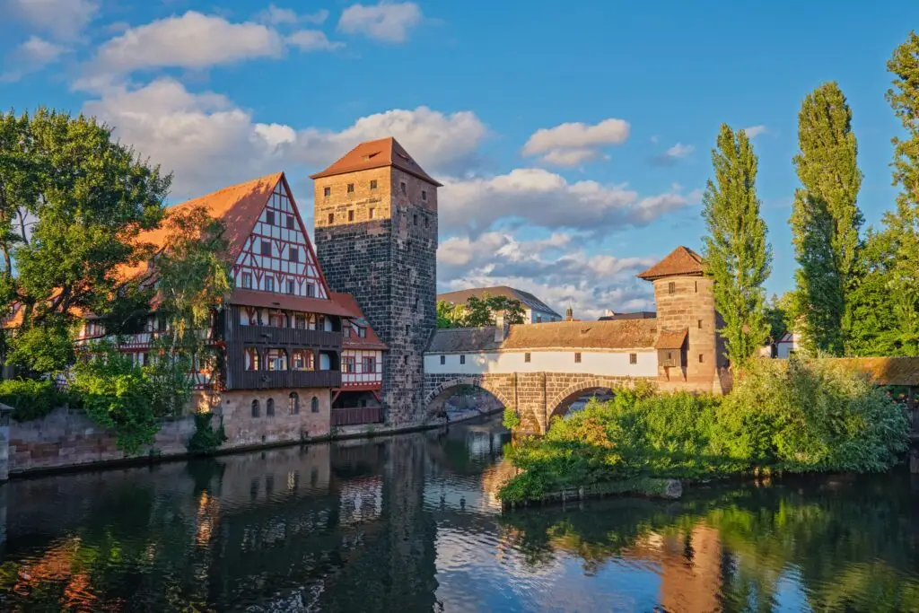 Historic medieval buildings and bridge over the Pegnitz River in Nuremberg, Germany, showcasing traditional Bavarian architecture and scenic old town views for Private Italy Tour