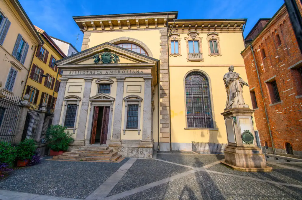 Biblioteca Ambrosiana historic library and art gallery courtyard with statue in Milan, Italy
