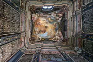 Bone-lined chapel interior and frescoed ceiling of the Capuchin Crypt in Rome, Italy