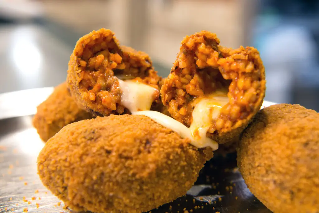 Suppli al telefono fried rice balls with melted mozzarella, traditional Roman street food in Italy