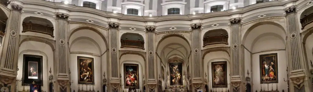 Panoramic interior of Chiesa del Pio Monte della Misericordia in Naples, Italy, with Baroque arches and historic paintings