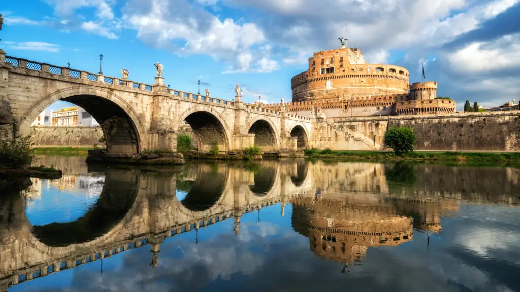 Castel Sant’Angelo and Ponte Sant’Angelo reflected in the Tiber River in Rome, Italy