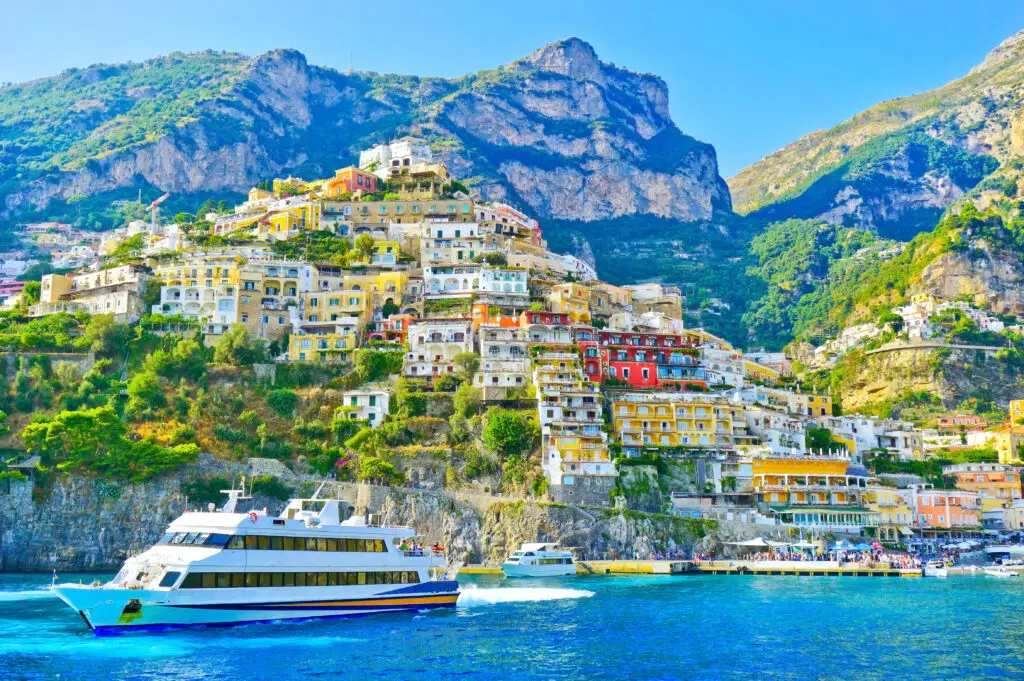 View of Positano village on the Amalfi Coast in Italy with colorful cliffside houses and boat on the sea