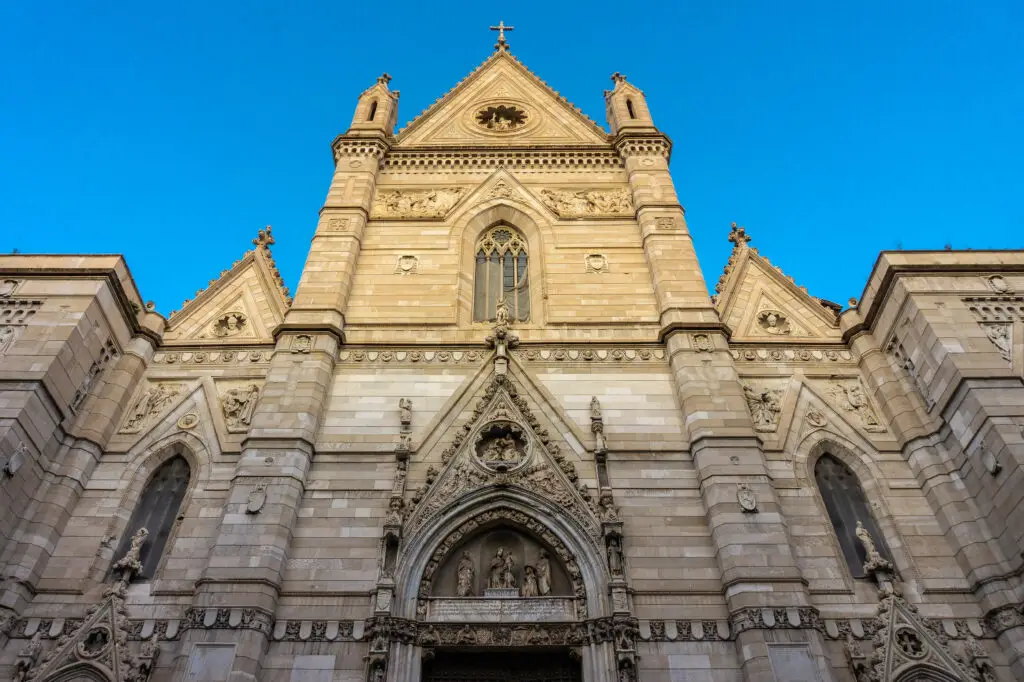 Facade of Duomo di San Gennaro cathedral in Naples, Italy with Gothic architecture and blue sky