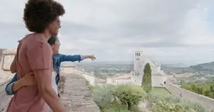 Couple sightseeing in Assisi, Italy, overlooking the Basilica of Saint Francis and Umbrian countryside on a romantic private Italy tour