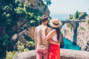 Couple enjoying the scenic view of Fiordo di Furore on the Amalfi Coast in Italy
