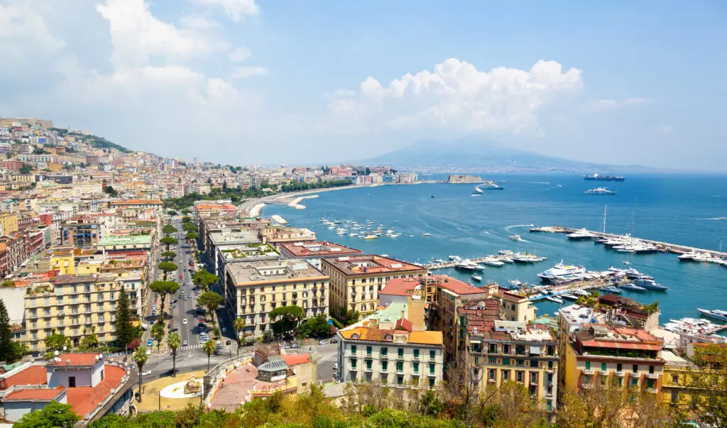 Panoramic view of Naples from Posillipo with the Bay of Naples, marina, city rooftops, and Mount Vesuvius in Italy