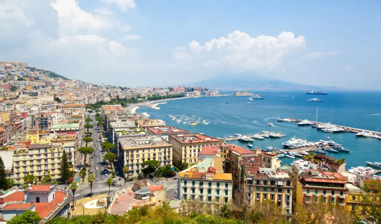 Panoramic view of Naples from Posillipo with the Bay of Naples, marina, city rooftops, and Mount Vesuvius in Italy