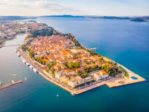 Aerial view of Zadar old town in summer, Croatia, with red rooftops, Adriatic Sea coastline and harbor boats