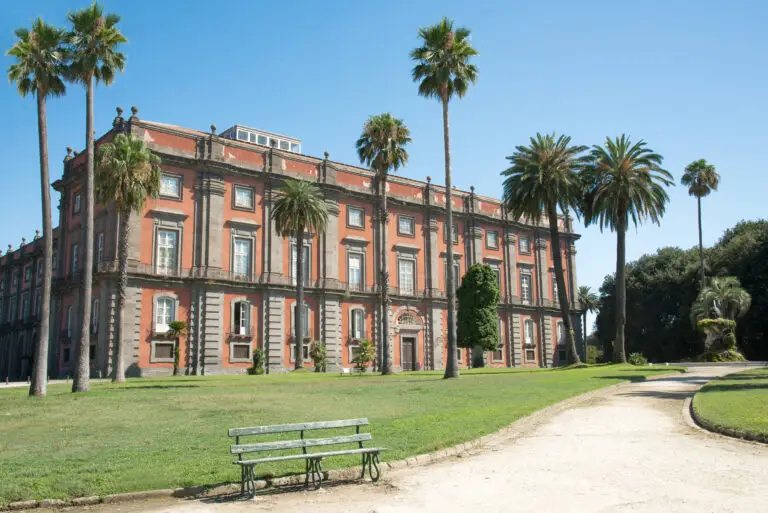 Royal Palace housing the National Museum of Capodimonte in Naples, Italy, with palm trees and gardens
