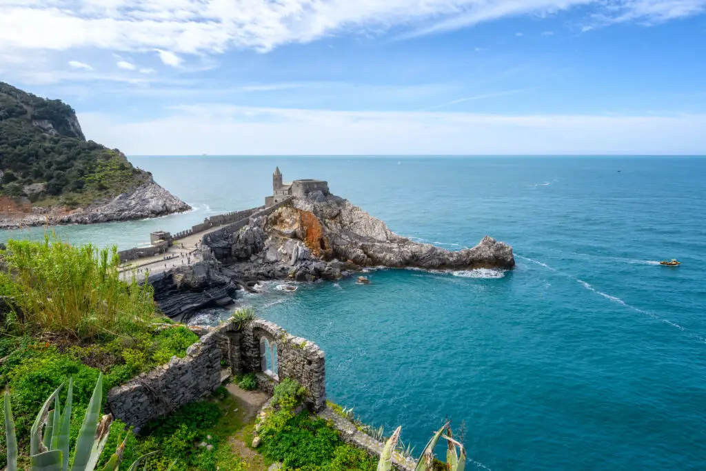 Aerial view of Church of St. Peter in Portovenere on the Ligurian coast of Italy with turquoise sea and rocky cliffs