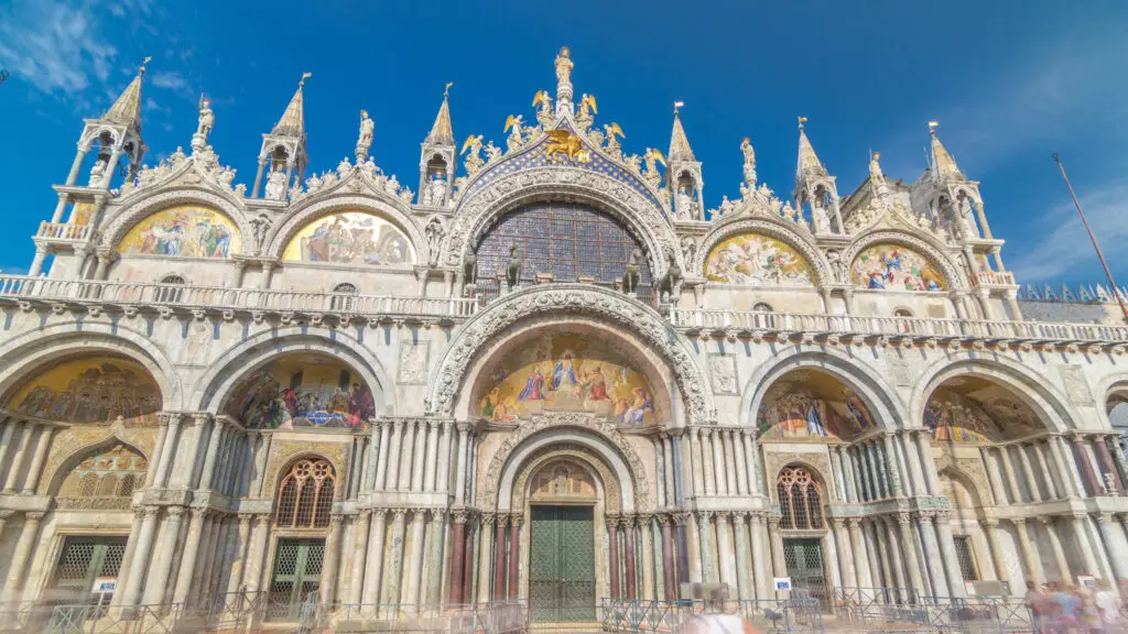 St Mark’s Basilica cathedral facade with mosaics in Venice Italy under blue sky