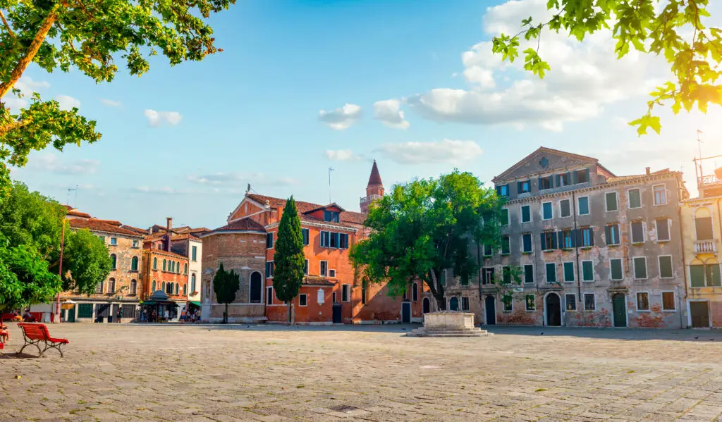 Campo San Polo square in Venice Italy with historic buildings, trees and sunny open plaza for private Italy tours