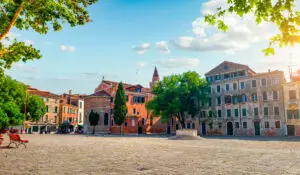 Campo San Polo square in Venice Italy with historic buildings, trees and sunny open plaza for private Italy tours