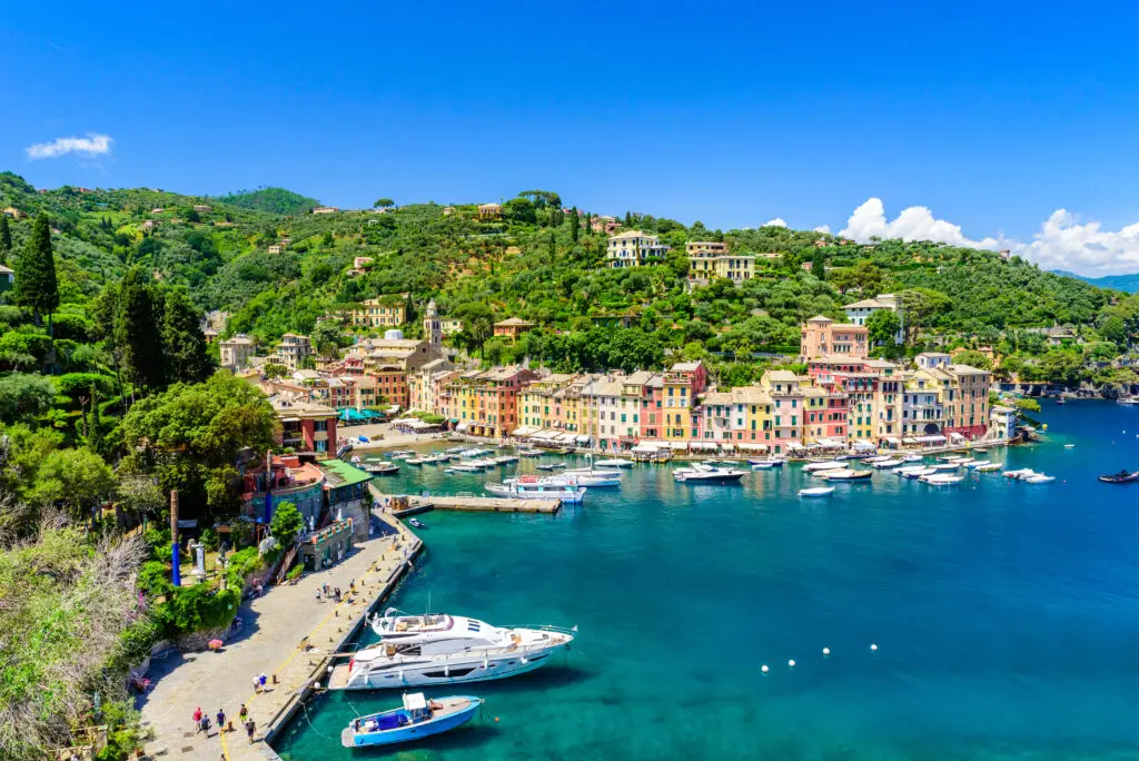 Portofino Italy harbor with colorful waterfront houses, yachts and turquoise Ligurian Sea on the Italian Riviera
