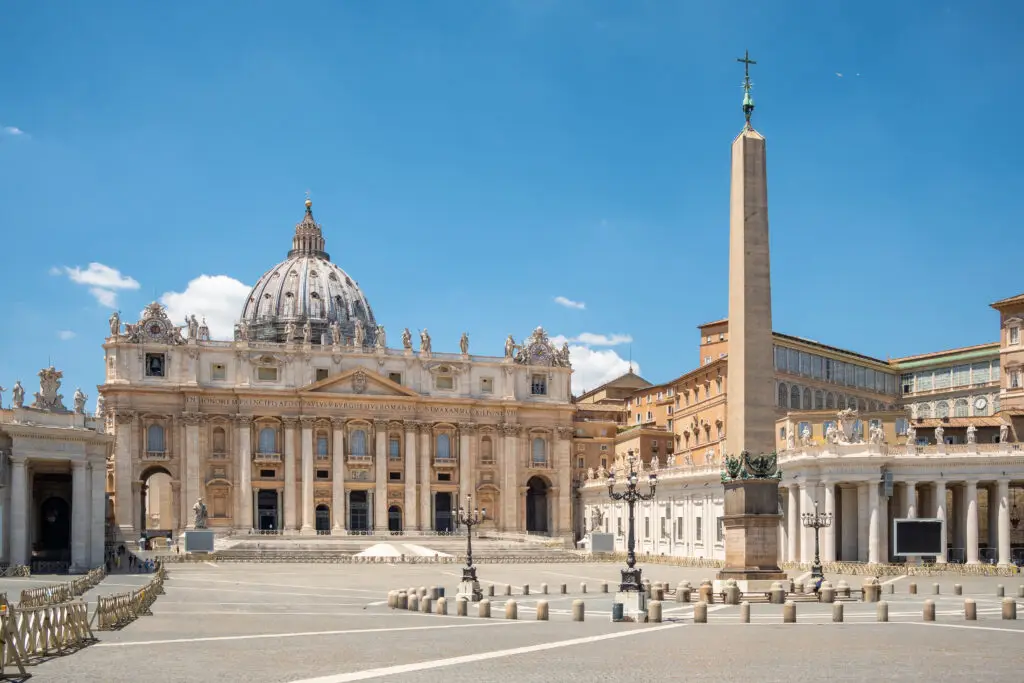 St. Peter’s Square and St. Peter’s Basilica in Vatican City, Rome, Italy with the Vatican obelisk on a sunny day
