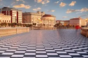 Terrazza Mascagni in Livorno, Italy at sunset with checkered promenade and seaside pavilion