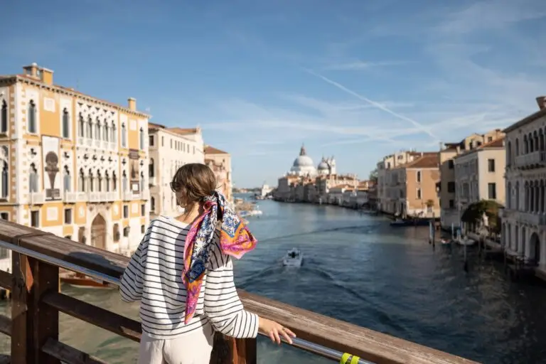Young woman enjoying the Grand Canal view from Accademia Bridge in Venice, Italy