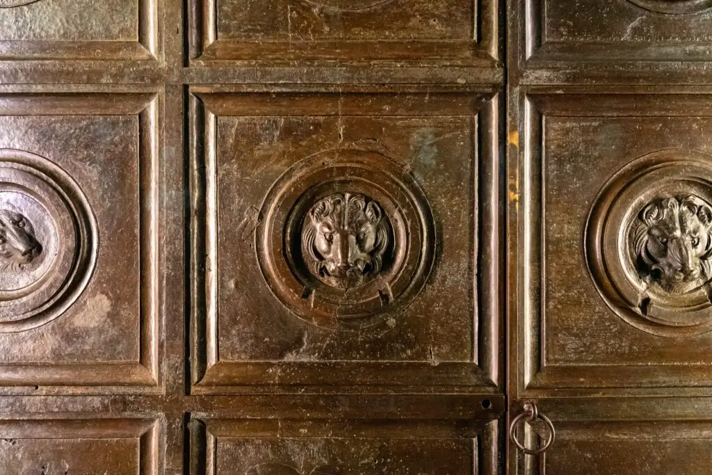Bronze doors with lion head reliefs at Museo dell Opera del Duomo in Florence, Italy