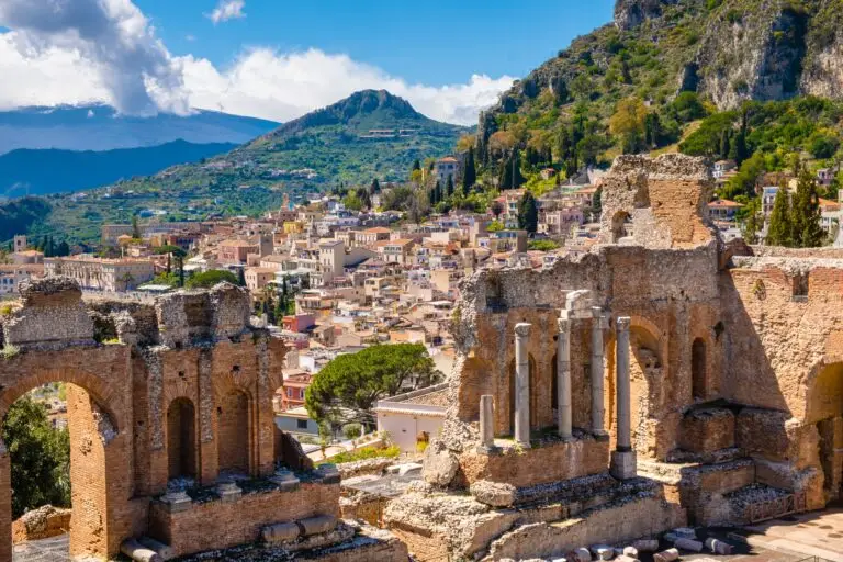 Ancient Greek Theater ruins in Taormina, Sicily, Italy with Mount Etna and hillside town views