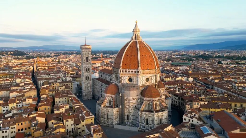 Aerial view of Florence Cathedral Duomo di Firenze and Giotto’s Bell Tower in Florence, Italy at sunset
