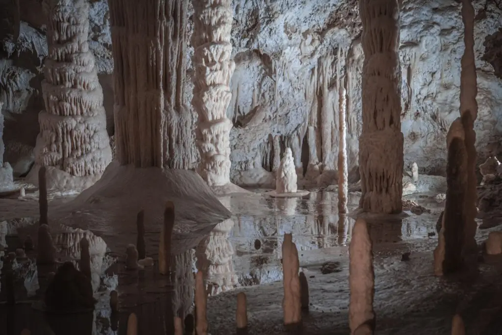 Karst formations with stalactites, stalagmites and reflective pools inside the Frasassi Caves in Italy