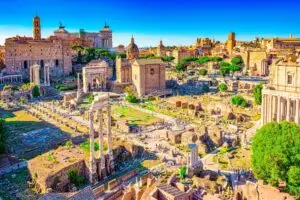 Panoramic view of the Roman Forum ruins in Rome, Italy with ancient temples, columns and historic city skyline