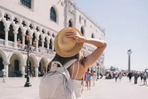 Young woman tourist with backpack visiting Doge’s Palace in Venice, Italy on a private Italy tour