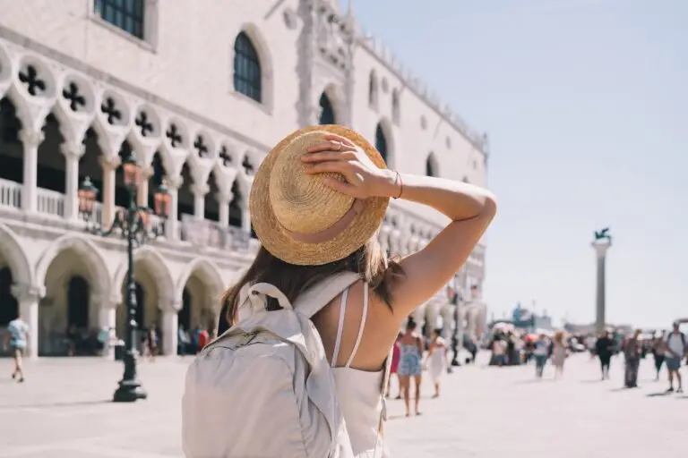Young woman tourist with backpack visiting Doge’s Palace in Venice, Italy on a private Italy tour