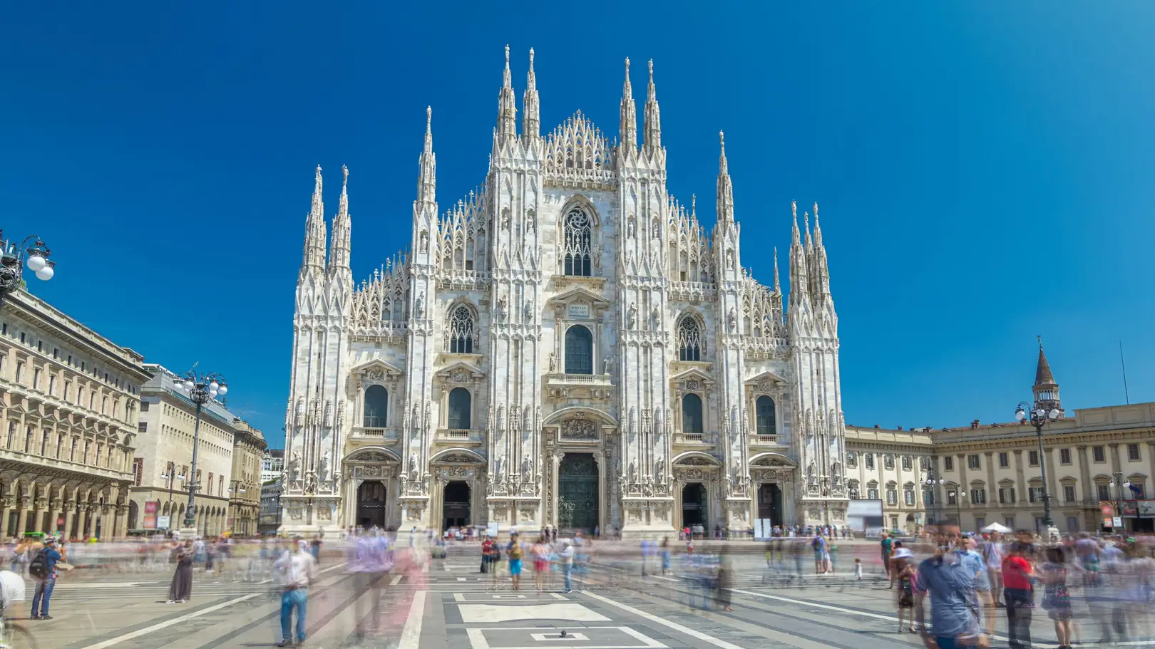 Milan Duomo Cathedral front view with people walking in Piazza del Duomo, Italy