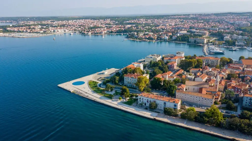 Aerial view of Zadar, Croatia coastline with the Sea Organ, red-roofed old town and turquoise Adriatic Sea
