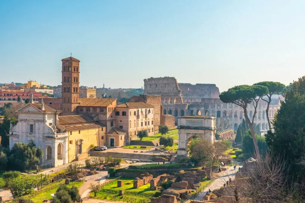 Aerial view of the ancient Colosseum and Roman Forum in Rome, Italy with historic ruins and city landmarks