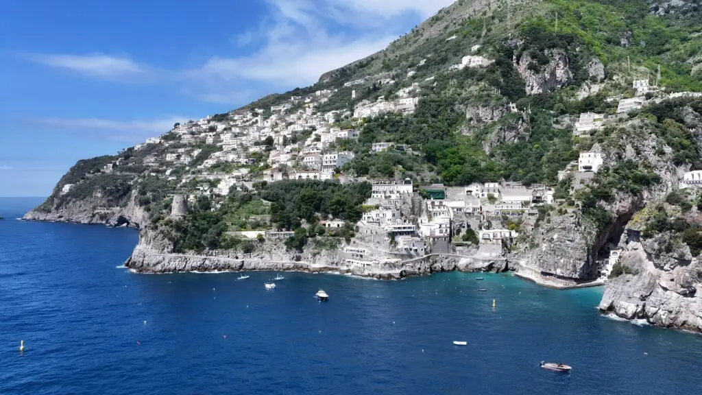 Amalfi Coast in Praiano, Salerno, Italy with cliffside village, turquoise sea and boats on the Mediterranean coastline