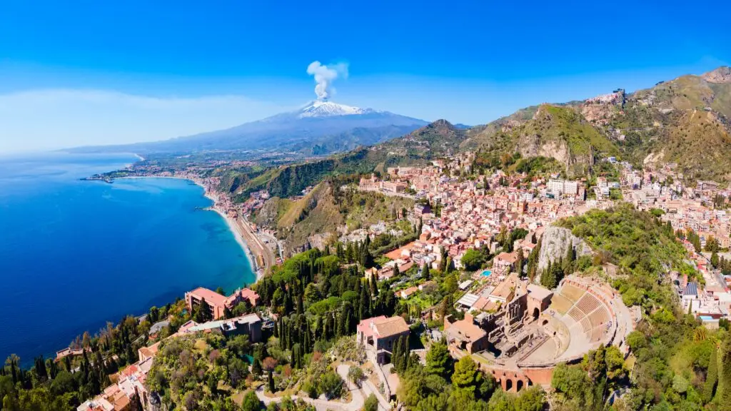 Ancient Theatre of Taormina overlooking the Sicilian coast and Mount Etna in Taormina, Italy