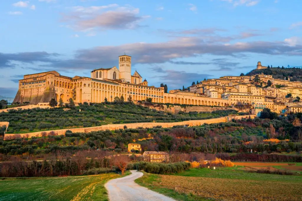 Assisi Italy skyline with the Basilica of Saint Francis overlooking the Umbrian countryside at sunset