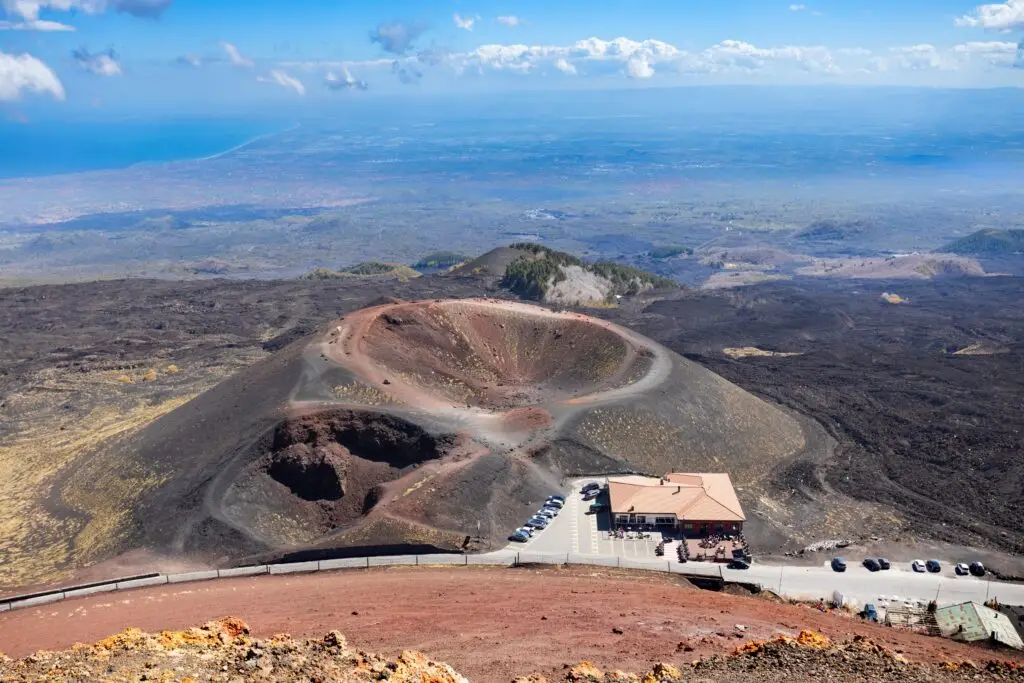 Mount Etna volcano crater and lava fields near Catania in Sicily, Italy, with panoramic views toward the coast