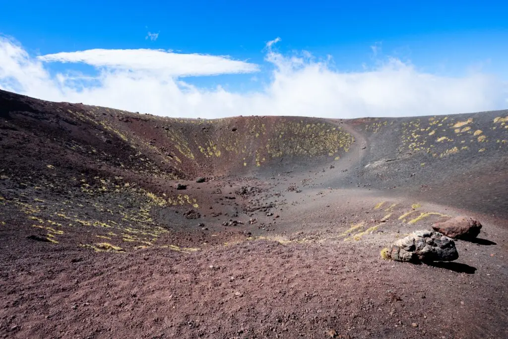 Silvestri Crater on Mount Etna volcano in Sicily, Italy, with volcanic rock landscape under a blue sky