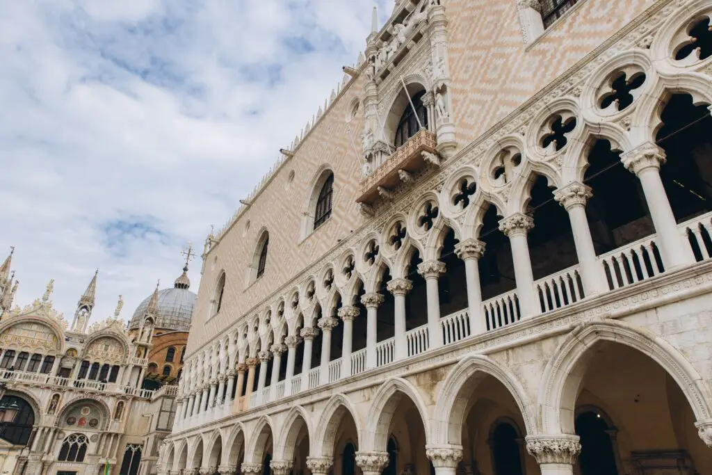 Historic Doge’s Palace Gothic architecture in Venice Italy with ornate arches beside St Mark’s Basilica