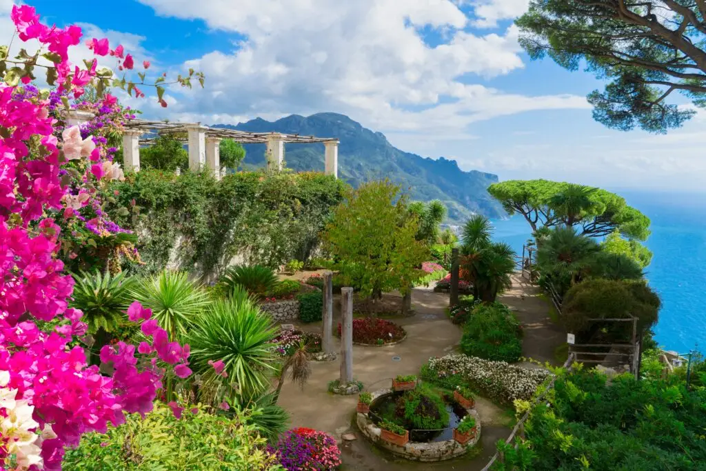 Ravello gardens overlooking the sea on the Amalfi Coast in Italy with vibrant flowers and mountain views