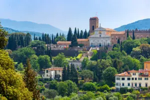 Basilica of San Miniato al Monte overlooking Florence, Italy, with Tuscan hills and cypress trees in the background