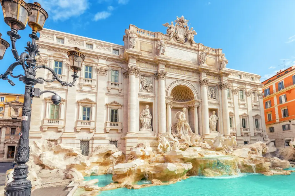 Trevi Fountain in Rome, Italy with Baroque sculptures and turquoise water on a sunny day